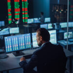 Professional Financial Data Analysts Working in a Modern Monitor